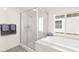 Bright bathroom features a soaking tub, step-in shower with glass door, and bright natural light at 3058 Casarano Ct, Henderson, NV 89044