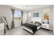 Stylish bedroom with a queen bed, contemporary decor, and a large window overlooking the neighborhood at 3058 Casarano Ct, Henderson, NV 89044