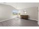 Bright bedroom with neutral walls, wood-look floors, and a view from multiple windows at 3058 Casarano Ct, Henderson, NV 89044