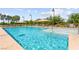 Beautiful community pool featuring clear blue water, lounge chairs, and umbrellas for relaxing poolside at 3058 Casarano Ct, Henderson, NV 89044