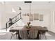Elegant dining room with a large wooden table, modern lighting, and stylish decor at 3058 Casarano Ct, Henderson, NV 89044