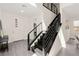 Bright entryway features a modern staircase with black railings and a sleek front door with glass accents at 3058 Casarano Ct, Henderson, NV 89044