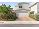 Charming two-story home featuring a two-car garage, well-manicured shrubs, and inviting curb appeal at 3058 Casarano Ct, Henderson, NV 89044