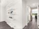 Hallway with floating shelves, modern flooring, and views into adjoining rooms with natural light at 3058 Casarano Ct, Henderson, NV 89044