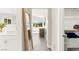 Bright hallway features gray flooring, view to the outdoors, and a walk-in closet at 3058 Casarano Ct, Henderson, NV 89044