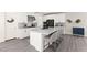 Sleek kitchen with white cabinetry, quartz countertops, a black refrigerator, and stylish bar stools at 3058 Casarano Ct, Henderson, NV 89044