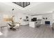 Bright, open kitchen features modern appliances, a large island, and a dining area with a rustic wooden table at 3058 Casarano Ct, Henderson, NV 89044
