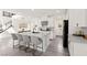 Modern kitchen boasts white cabinets, stainless steel appliances, and a central island with bar seating at 3058 Casarano Ct, Henderson, NV 89044