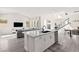Open concept living space featuring a modern kitchen with island and a cozy living room area at 3058 Casarano Ct, Henderson, NV 89044