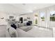 Spacious living area with an open layout to the modern kitchen and access to the backyard at 3058 Casarano Ct, Henderson, NV 89044