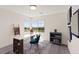 Bright home office with a modern desk, corner windows, and neighborhood views at 3058 Casarano Ct, Henderson, NV 89044