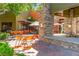 Outdoor seating area with tables, chairs, umbrellas, and mature landscaping, perfect for dining at 3058 Casarano Ct, Henderson, NV 89044