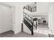 Modern staircase with metal railings leading to the upper level, with open access to the kitchen at 3058 Casarano Ct, Henderson, NV 89044