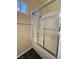 Bright bathroom with a glass door shower, tiled walls, and dark tile floors at 3679 Funston Way, Las Vegas, NV 89129