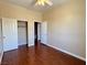 Cozy bedroom features a ceiling fan, wood floors, and a closet for ample storage at 3679 Funston Way, Las Vegas, NV 89129