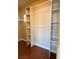 Walk-in closet featuring built-in shelving units and wood floors at 3679 Funston Way, Las Vegas, NV 89129