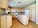 Bright kitchen featuring an island, granite countertops, and ample cabinetry at 3679 Funston Way, Las Vegas, NV 89129
