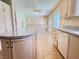 Bright kitchen with granite counters, wood cabinets, and tile flooring extending to an adjacent area at 3679 Funston Way, Las Vegas, NV 89129