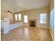 Open living room featuring a fireplace, vaulted ceiling, and neutral colors at 3679 Funston Way, Las Vegas, NV 89129