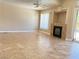 Spacious living room featuring tile flooring, a fireplace, and a sliding glass door to the exterior at 3679 Funston Way, Las Vegas, NV 89129