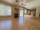 Open-concept living room with a fireplace, tile floors, and access to a pool through sliding doors at 3679 Funston Way, Las Vegas, NV 89129
