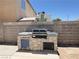 Outdoor kitchen with a built-in grill and stone veneer is perfect for backyard entertaining at 3679 Funston Way, Las Vegas, NV 89129