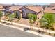 Charming single-story home featuring manicured landscaping and a brick driveway at 369 Old Erie Pl, Henderson, NV 89011
