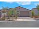 Beautiful single-story home features a two-car garage and a stone accent wall at 369 Old Erie Pl, Henderson, NV 89011
