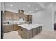 Stylish kitchen with a large center island, pendant lighting, and modern stainless steel appliances at 369 Old Erie Pl, Henderson, NV 89011