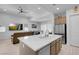 Modern kitchen featuring an island, stainless steel appliances, and an open layout to the dining and living spaces at 369 Old Erie Pl, Henderson, NV 89011