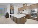 Well-lit kitchen with a large island, stainless steel appliances, and custom cabinetry, perfect for cooking at 369 Old Erie Pl, Henderson, NV 89011