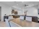 Bright, open-concept living space showcasing a dining area and kitchen with a central island and breakfast bar at 369 Old Erie Pl, Henderson, NV 89011