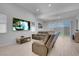 Open concept living room with a relaxing couch and bright windows at 369 Old Erie Pl, Henderson, NV 89011