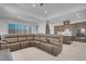 Spacious living room with a large sectional couch and modern ceiling lights at 369 Old Erie Pl, Henderson, NV 89011