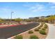 Elegant community entrance featuring lush greenery, and well-paved streets at 390 Coastal Redwood St, Las Vegas, NV 89138
