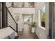 Inviting foyer featuring a modern staircase, hardwood floors, and ample natural light at 390 Coastal Redwood St, Las Vegas, NV 89138