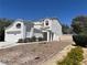 Charming two-story white home featuring desert landscaping, a two-car garage and well maintained perimeter walls at 3929 Dream St, Las Vegas, NV 89108