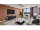 Bright living room with updated furniture, modern entertainment unit, and floor-to-ceiling windows with city views at 3930 University Center Dr # 804, Las Vegas, NV 89119