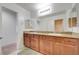Bathroom with double sinks, granite countertops, and a large mirror at 3949 Amanda Bay Ave, North Las Vegas, NV 89081