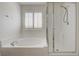 Bright bathroom featuring a soaking tub, sleek shower, and modern fixtures at 3949 Amanda Bay Ave, North Las Vegas, NV 89081