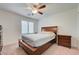 Comfortable bedroom with a ceiling fan, carpet, and white shutters at 3949 Amanda Bay Ave, North Las Vegas, NV 89081