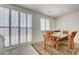 A well-lit dining area featuring a wooden table set for six, shutters, and a decorative area rug at 3949 Amanda Bay Ave, North Las Vegas, NV 89081