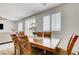 Bright dining area with a wood table, shuttered windows, and an orchid centerpiece at 3949 Amanda Bay Ave, North Las Vegas, NV 89081