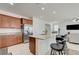 Open-concept kitchen with island, bar seating, and stainless steel refrigerator at 3949 Amanda Bay Ave, North Las Vegas, NV 89081