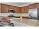 Stylish kitchen featuring granite countertops, stainless steel appliances, and wooden cabinets at 3949 Amanda Bay Ave, North Las Vegas, NV 89081