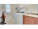 Functional laundry room with modern washer/dryer, storage cabinets, and utility sink at 3949 Amanda Bay Ave, North Las Vegas, NV 89081