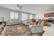 Bright and airy living room with a ceiling fan, plush sofas, and an area rug with a dining area view at 3949 Amanda Bay Ave, North Las Vegas, NV 89081