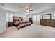 Spacious bedroom with large bed, dresser, ceiling fan and plantation shutters at 3949 Amanda Bay Ave, North Las Vegas, NV 89081