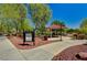 Community park with a large green space, covered seating area, mature trees, and manicured landscaping at 3949 Amanda Bay Ave, North Las Vegas, NV 89081
