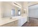Bright bathroom featuring a long vanity with dual sinks and a large mirror at 4516 Cielo Ln, Las Vegas, NV 89130